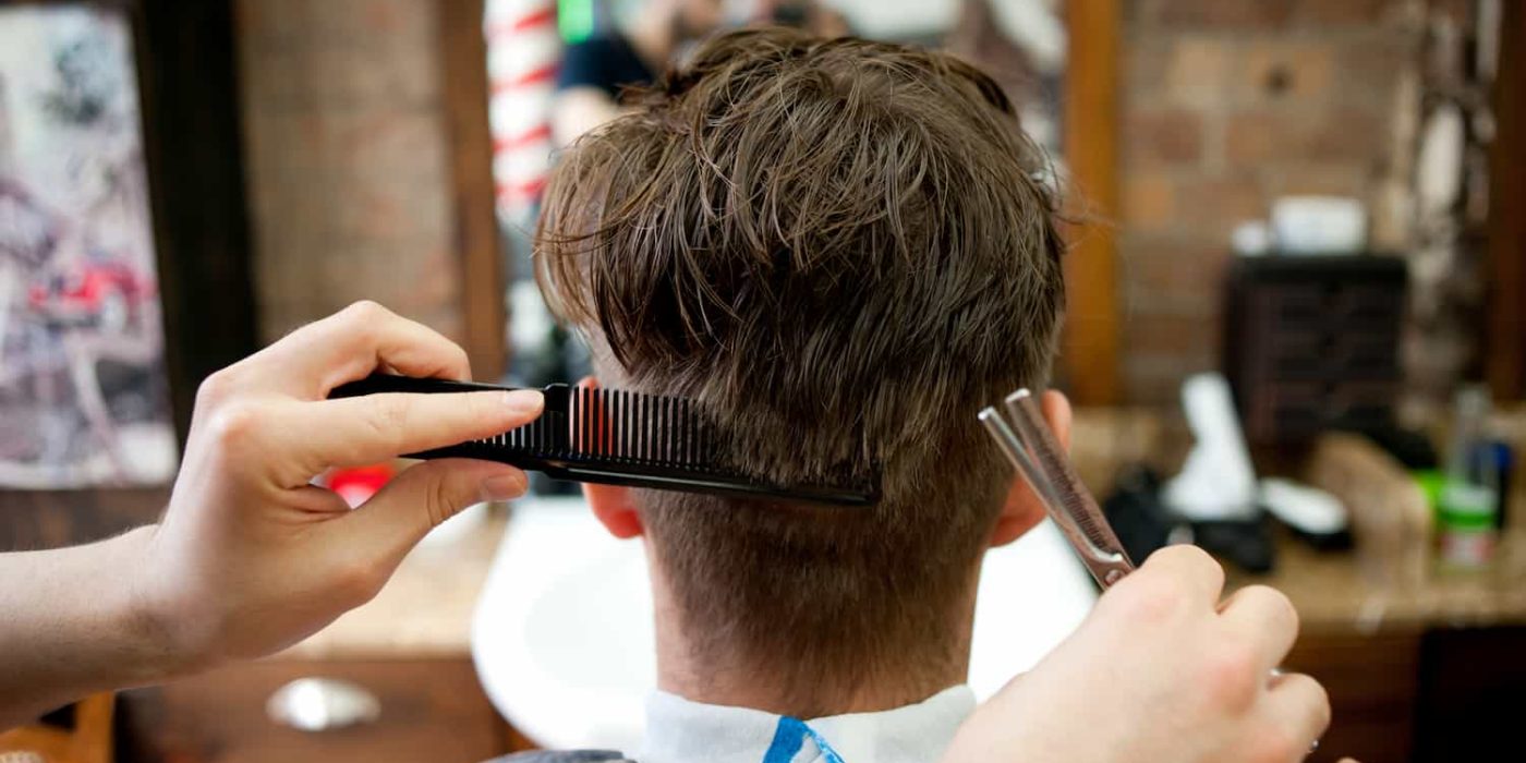 rear-view-of-young-man-in-barbershop-having-haircu-2023-11-27-04-58-29-utc.jpg